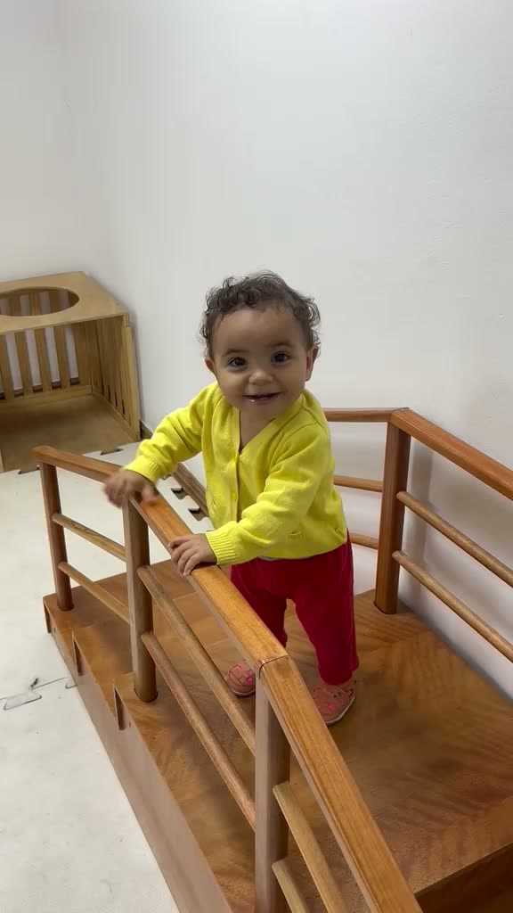 Bebê sorrindo na estrutura de psicomotricidade da escola